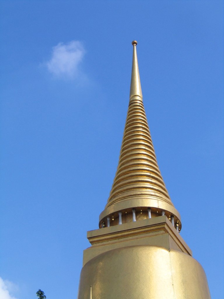Gilded temple spire against a clear sky — detail-driven cultural itineraries in Asia